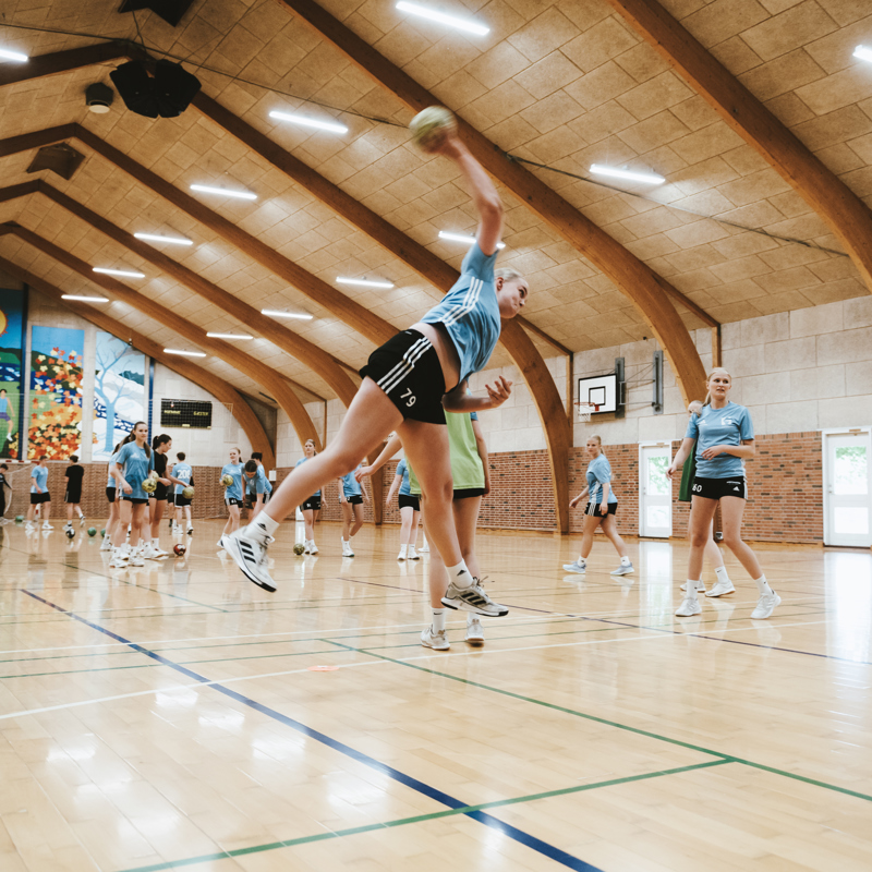 Efterskoleelever spiller håndbold i hal på Gudenaadalens efterskole. 